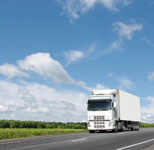 white truck on  summer country highway under blue sky, landscape